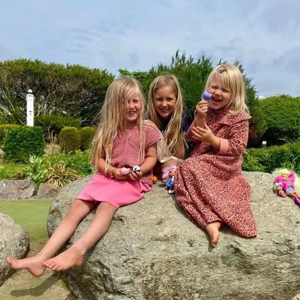 Drie meisjes op een rots tussen de banen